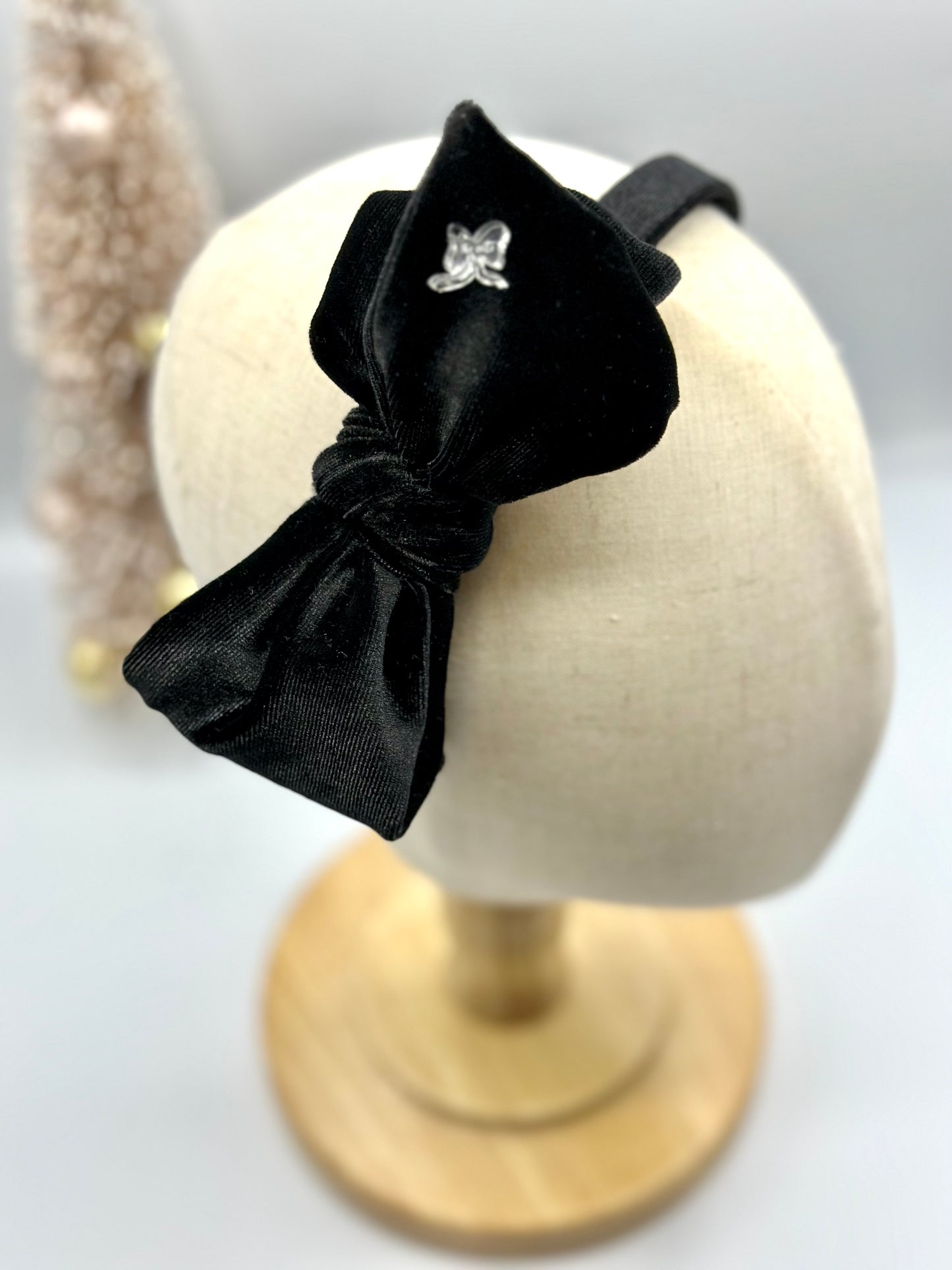 Hard headband with suede bow.