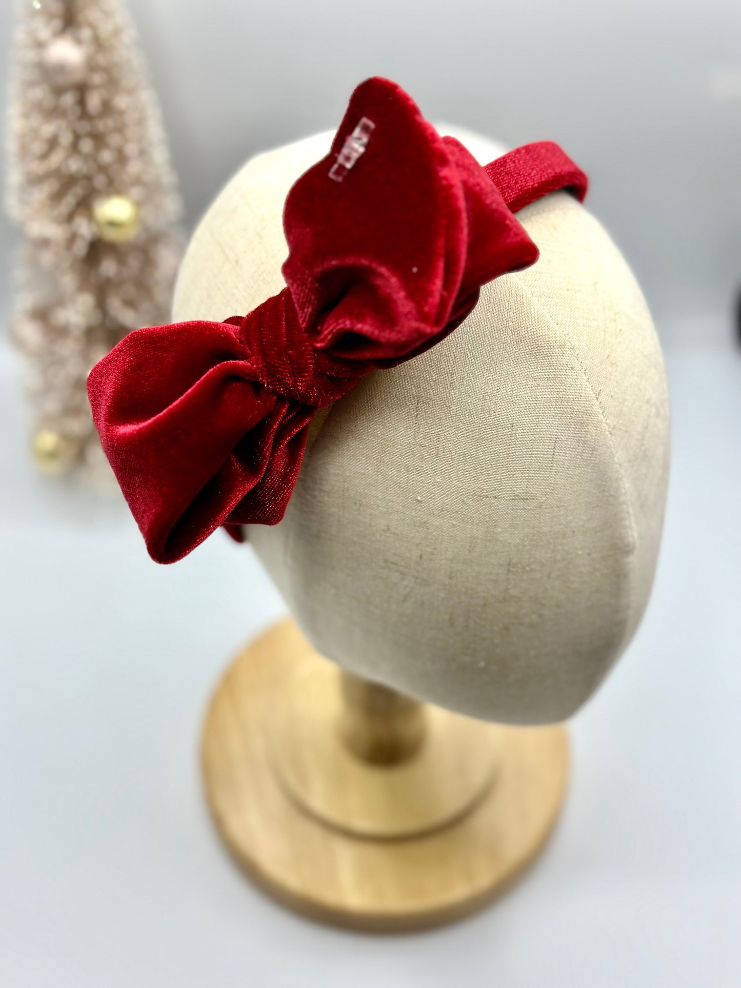 Hard headband with suede bow.