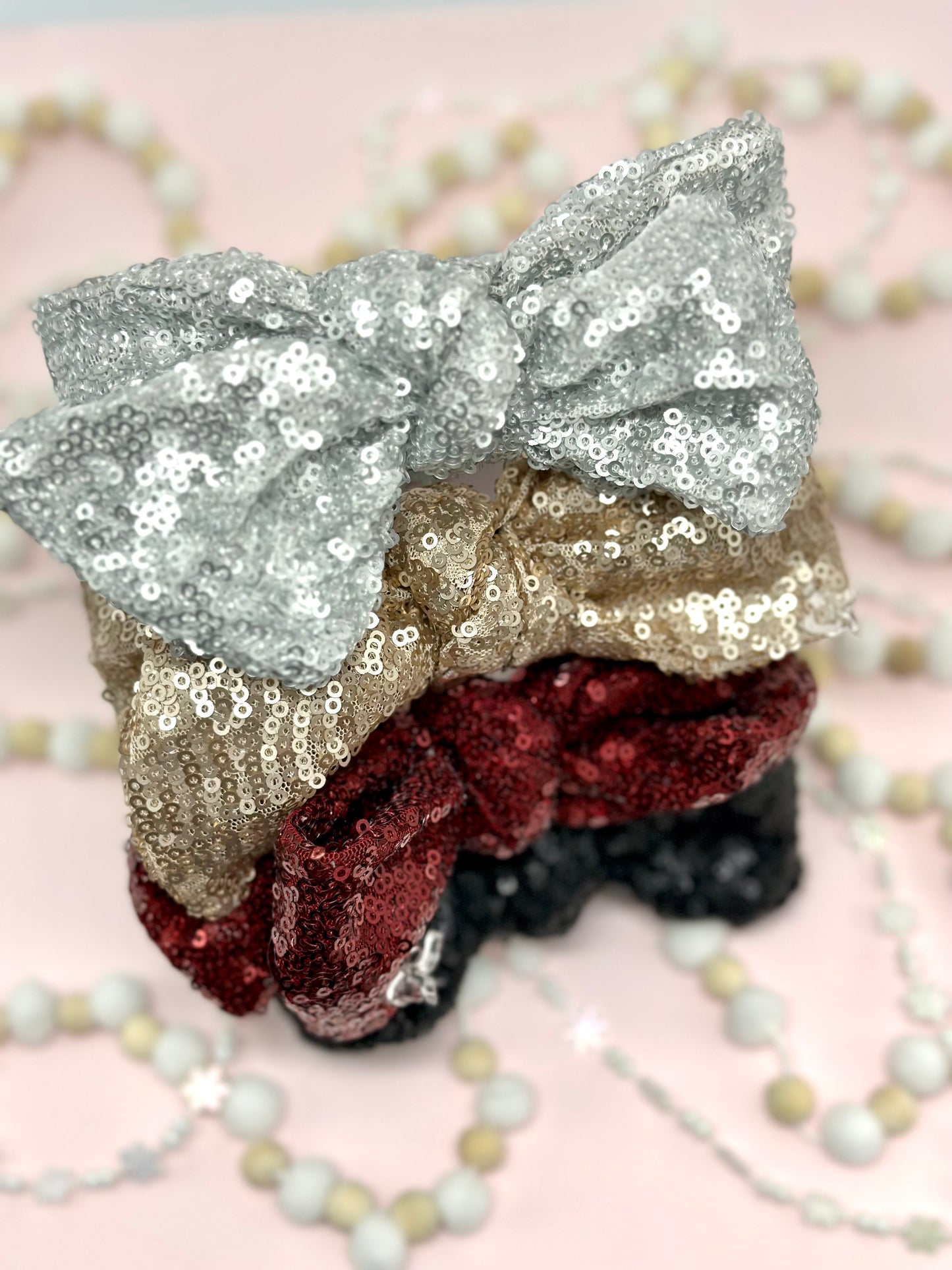 Hard headband with sequin bow.