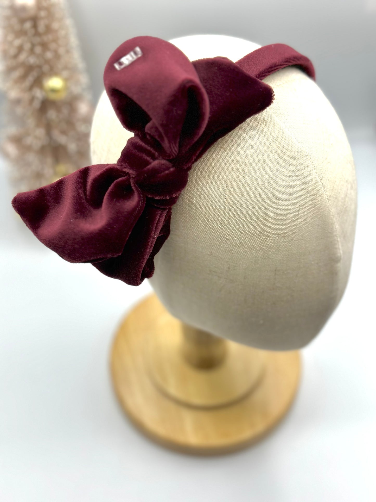 Hard headband with suede bow.